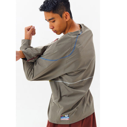 Person wearing a gray long-sleeve shirt with UPF50+ and quick-dry features on a white background